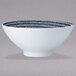 A white Oneida porcelain pedestal bowl with a black and white pattern.