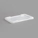 A white plastic cover for a Channel L815 lug on a gray surface.