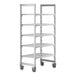 A white plastic Cambro Camshelving Premium mobile shelving unit with four shelves on wheels.