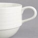 A close-up of a white Oneida Manhattan porcelain cup with a handle.