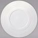 A Oneida warm white porcelain coupe plate with a wide rim and a circular pattern.