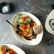 A close-up of a bowl of soup with a spoon.