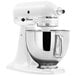 A white KitchenAid Artisan stand mixer with a bowl.