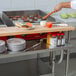 A Regency stainless steel plate shelf on a table.