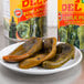 A plate of whole poblano peppers next to a can of Del Sol whole poblano peppers.