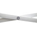 A white metal cross with round ends and metal brackets with screws.