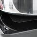A Vollrath 2/3 size chafer mat on a stainless steel counter.