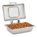 A Vollrath stainless steel chafing dish with a glass top over a stainless steel food pan inside.