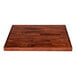 A Lancaster Table & Seating wooden butcher block table top with a mahogany finish.