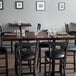 A Lancaster Table & Seating butcher block table with glasses on it.