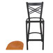 A Lancaster Table & Seating black cross back bar stool with a cherry wood seat.