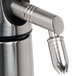 A close-up of a stainless steel iSi dispensing nozzle.