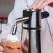 A person using an iSi dispensing nozzle to make a dessert.