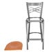 A Lancaster Table & Seating metal bar stool with a cherry wood seat.