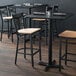 A black finish cross back bar stool with a natural wood seat and a detached seat design.