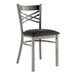 A Lancaster Table & Seating black metal cross back chair with a black padded seat.