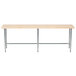 An Advance Tabco wood top work table with a galvanized metal base.