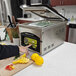 A person using an ARY VacMaster chamber vacuum to cut lemons on a table.