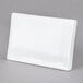 A white rectangular ceramic card sign on a gray surface.