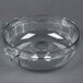 A clear plastic bowl with handles and a hole in the bottom.