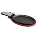 A pre-seasoned cast iron fajita skillet with a grey silicone coated handle.