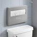 A stainless steel surface-mounted toilet seat cover dispenser installed above a toilet tank.