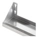 A stainless steel Lavex wall mount shelf with holes in the corners.