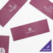 A burgundy rectangular paper napkin band with white text.