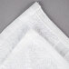 A pack of white Oxford hand towels on a gray surface.