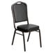 A black Flash Furniture banquet chair with a black vinyl seat.