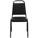 A Flash Furniture black banquet chair with black metal legs.
