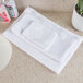 A white Oxford wash cloth on a counter.