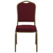 A burgundy banquet chair with gold frame.