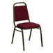 A burgundy Flash Furniture banquet chair with a metal frame.