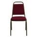 A burgundy Flash Furniture banquet chair with a metal frame.