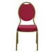 A burgundy Flash Furniture banquet chair with a gold frame.