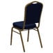A navy blue banquet chair with a gold frame.