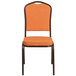 An orange Flash Furniture banquet chair with a copper vein frame.