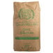 A brown bag of Grain Millers Quick Rolled Oats with green text.