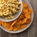 A plate of macaroni and cheese and Martin's Bar-B-Q Waffle Cut Potato Chips.