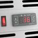 A digital display with numbers and symbols on an Avantco countertop refrigerated sushi display case.