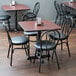 A black Lancaster Table & Seating cast iron table base in a restaurant dining area.