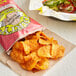 A bag of Dirty Potato Chips Mesquite BBQ potato chips on a table.