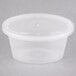 A Newspring clear oval plastic souffle container with a clear lid.