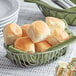 A basket of King's Hawaiian dinner rolls on a table.