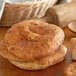 A stack of Father Sam's Bakery white pita pocket bread on a table.