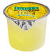 A yellow container of Luigi's lemon Italian ice with a yellow substance in it.