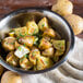 A bowl of White Chef potatoes with parsley and garlic.