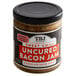 A jar of TBJ Gourmet Sweet Chili Uncured Bacon Jam with a black lid on a table.