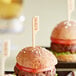 A plate of hamburgers with Tablecraft gluten-free food markers on them.